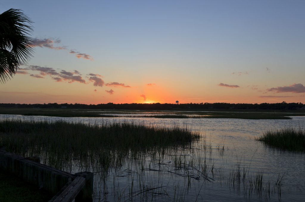 Sun setting over the canal waters at Cherry Grove Beach in South Carolina